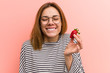 © Asier - Portrait of young woman tasting a fresh strawberry