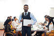 © AS Photo Family - Face of handsome african business man, holding laptop and show thumb up on the background of business peoples multiracial team meeting, sitting in office table.