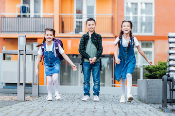 Wall Mural - Happy school children in uniform, back to school,happyness and education concept.