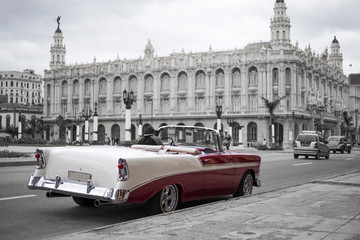 Wall Mural - colorkey of red and white classic car in front of grand theatre in havana, cuba