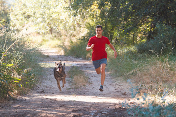 runner running across the field with his dog