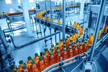 Conveyor Belt, Juice In Bottles On Beverage Plant Or Factory Interior In Blue Color, Industrial Production Line