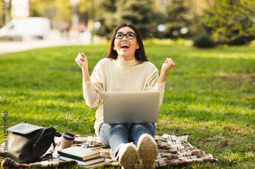 Cuadros en Lienzo Euphoric girl watching exam results on laptop