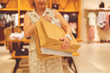© Mihail - woman with many paper bags in the clothes store, making some purchases