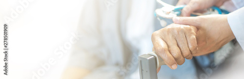 Fotografía Elderly female hand holding hand of young caregiver at nursing home