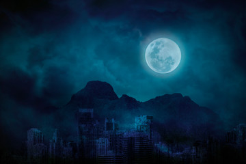 blue full moon in city abandonment with the mountains and clouds, bright and dark at midnight, citys