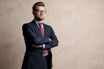 Poster - Hopeful businessman holding his hand crossed and looking away