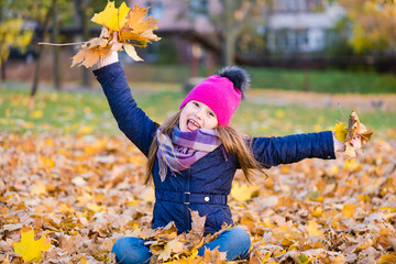 Adorable girl having fun on autumn day