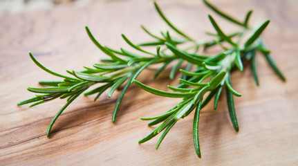 Rosemary Fresh Herbs on wooden board.