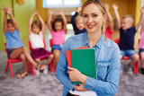 Fototapeta  - Portrait of smiling female teacher in the preschool