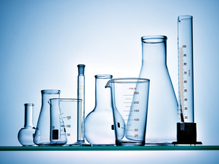 Wall Mural - different laboratory glassware with liquid and with reflection