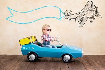 Canvas Print - Funny kid driving toy car indoor.