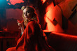 © Sergey - Image of young blonde in red jacket looking at camera with cocktail in her hand in nightclub