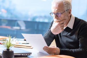 Wall Mural - Senior businessman reading a document