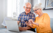 © leszekglasner - Senior couple checking bills using laptop at home