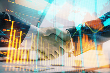 Multi exposure of financial chart and map on office background with two businessmen handshake. Concept of success in business