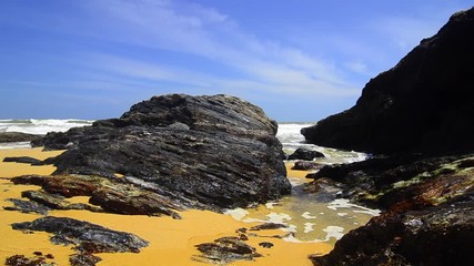 Wall Mural - footage of tropical seascape under bright sunny day and blue sky background. wave hitting the shoreline