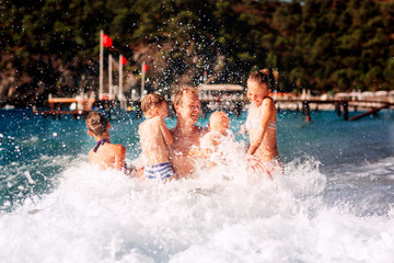 Sticker - Happy kids with his father on the beach having fun