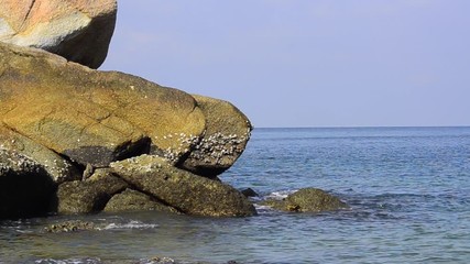 Wall Mural - footage of tropical seascape under bright sunny day and blue sky background. wave hitting the shoreline