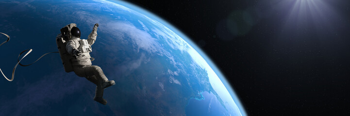 Wall Mural - astronaut hovering in orbit of planet earth
