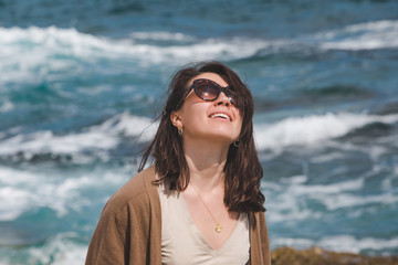 Wall Mural - woman at sea beach enjoying power of nature. windy weather