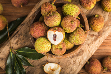 Poster - Fresh lychees on a wooden board background