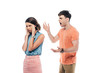 © LIGHTFIELD STUDIOS - irritated young man gesturing while quarreling at offended girlfriend isolated on white