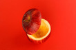 Healthy Red Cut Apple floating top slice juice drink idea concept on red background