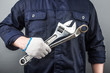 © dashu83 - automechanic in overalls holding wrench or spanner