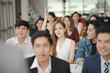 © linghaa - Young asian woman in seminar group raising up hand for asking the speaker in question and answer time in meeting room, woman  have a question in training class. Business seminar and training concept.