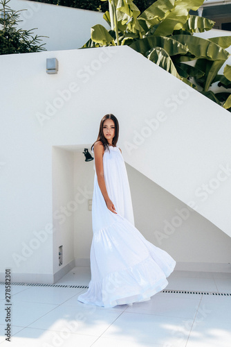 Young Woman With Dark Hair In Luxurious Summer Dress Relaxing At