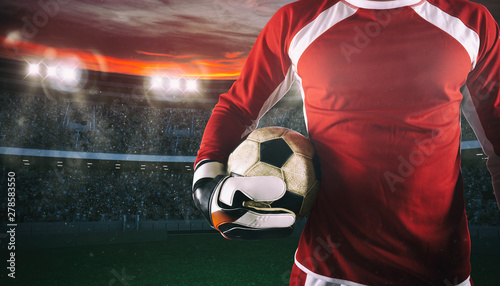 Fotografía Goalkeeper ready to play with ball in his hands at the stadium