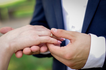 The groom puts the ring on the bride. Wedding ceremony