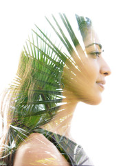 Double exposure profile portrait of a naturally beautiful happy woman and a tree with bright green leaves