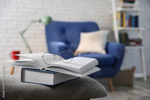 Cuadros en Lienzo Books with glasses on bench in room