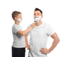 Sticker - Son applying shaving foam on dad's face, white background