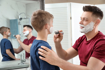 Sticker - Dad applying shaving foam on son's face at mirror in bathroom