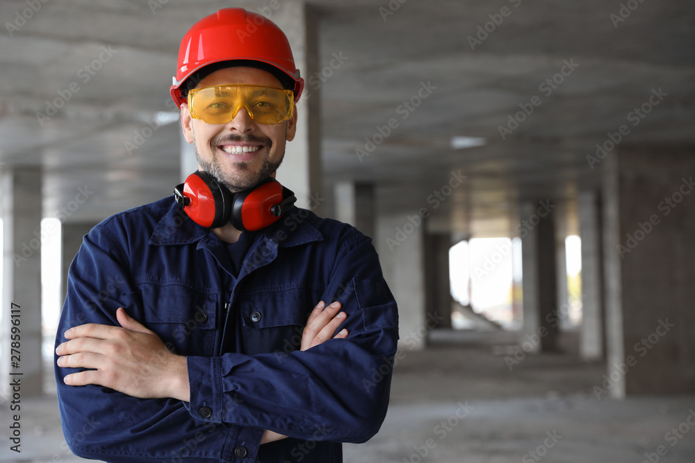 Professional engineer in safety equipment at construction site, space for text - obrazy, fototapety, plakaty 