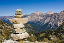 Stack Of Stones Rocks Trail Marker Cairn In The Mountains, North Cascades National Park, Washington State. Hiking, Wilderness, Direction, Waypoint Concept Background.