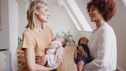 Wall Mural - Two Mothers Meeting Holding Newborn Babies At Home In Loft Apartment