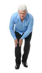 Poster - Full length portrait of senior man having knee problems on white background