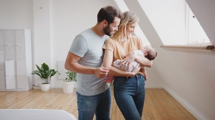 Wall Mural - Close Up Of Loving Parents Holding Newborn Baby Son At Home In Loft Apartment