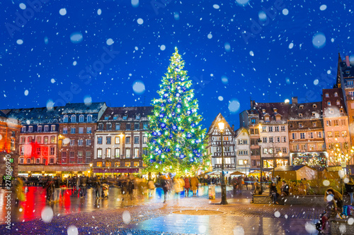 Christmas tree and xmas market at Kleber Square at night  in medieval city of Strasbourg - capital of Noel, Alsace, France.