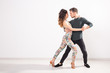 © satura_ - Salsa, kizomba and bachata dancers on white background with copy space. Social dance concept