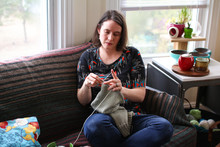 A Woman Sits And Knits