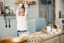 Child In A Kitchen. Little Girl With A Dough.