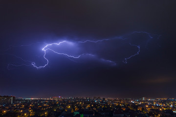 Wall Mural - urban landscape, thunderstorm and lightning across the sky