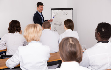 Smiling male giving presentation for medics