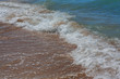 Sea waves running on the sandy beach