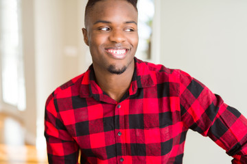 Poster - Handsome african american man looking away to side with smile on face, natural expression. Laughing confident.